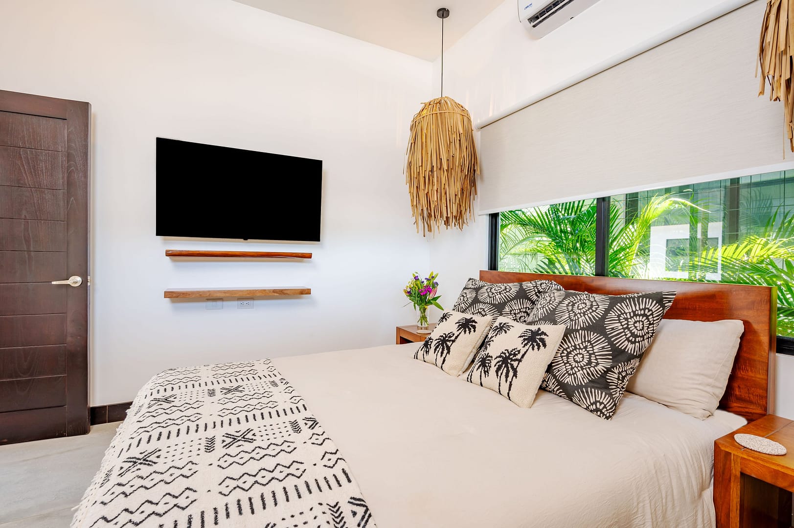 Bedroom with TV on the wall and boho theme decor